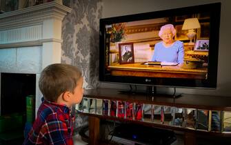 Photographer's son watches from home as Queen Elizabeth II Addresses The Nation On The 75th Anniversary Of VE Day on May 08, 2020. (Photo by Robin Pope/NurPhoto via Getty Images)