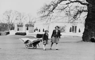 Princess Elizabeth and her sister Princess Margaret (1930 - 2002) pulling a lawn chair on wheels in the terraces at the back of the Royal Lodge, Windsor, UK, April 1940.  (Photo by Lisa Sheridan/Hulton Archive/Getty Images)
