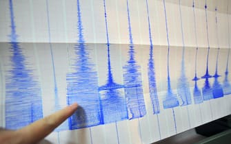 A man points at a seismic chart at the Central Weather Bureau in Taipei on March 4, 2010 after a 6.4 magnitude rocked southern Taiwan near the island's second largest city of Kaohsiung.  The quake hit about 70 kilometres (about 40 miles) from the main southern city of Kaohsiung, the US Geological Survey said, and it was felt as far away as the capital Taipei in the north of the island.   AFP PHOTO / Sam YEH (Photo credit should read SAM YEH/AFP via Getty Images)