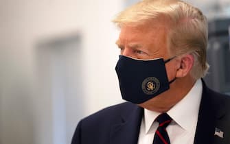 TOPSHOT - US President Donald Trump wears a mask as he tours a lab where they are making components for a potential vaccine at the Bioprocess Innovation Center at Fujifilm Diosynth Biotechnologies in Morrisville, North Carolina on July 27, 2020. (Photo by JIM WATSON / AFP) (Photo by JIM WATSON/AFP via Getty Images)