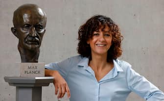 French researcher in Microbiology, Genetics and Biochemistry Emmanuelle Charpentier poses for photographers next to a bust of Max Planck in Berlin, on October 7, 2020. - Emmanuelle Charpentier of France and Jennifer Doudna of the US on October 7, 2020 won the Nobel Chemistry Prize for research into the gene-editing technique known as the CRISPR-Cas9 DNA snipping tool. (Photo by Odd ANDERSEN / AFP) (Photo by ODD ANDERSEN/AFP via Getty Images)