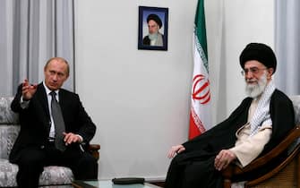 Russian President Vladimir Putin gestures during a meeting with Iran's supreme leader Ayatollah Ali Khamenei (R) in Tehran 16 October 2007. Putin today warned against military action on Iran and backed its right to nuclear energy, during the first visit to the country by a Kremlin chief since World War II. Putin, attending a summit meeting of Caspian Sea states, arrived in the Iranian capital amid heavy security and secrecy over his travel plans after reports that a squad of suicide bombers planned to kill him. AFP PHOTO/STR (Photo by STR / AFP) (Photo by STR/AFP via Getty Images)