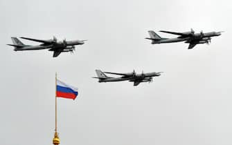 Russian Tupolev Tu-95 turboprop-powered strategic bombers fly above the Kremlin in Moscow, on May 7, 2014, during a rehearsal of the Victory Day parade. Russia celebrates the1945 victory over Nazi Germany on May 9. AFP PHOTO / YURI KADOBNOV        (Photo credit should read YURI KADOBNOV/AFP via Getty Images)