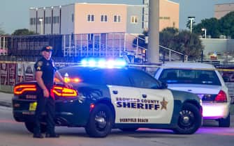 epa06525842 Law enforcement officers stand guard after a shooting at Marjory Stoneman Douglas High School in Parkland, Florida, USA, 14 February 2018. Multiple fatalities have been reported and several more injured at a high school northwest of Miami. According to law enforcement the suspect is in custody. Some media are reporting the suspect as former student, Nicolas Cruz.  EPA/GIORGIO VIERA