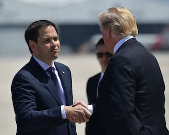US President Donald Trump greet Sen. Marco Rubio(R-FL) after stepping off Air Force One upon arrival at Miami International Airport in Miami on April 16, 2018. 
Trump is heading to Hialeah to hold a roundtable discussion on tax reform.  / AFP PHOTO / MANDEL NGAN        (Photo credit should read MANDEL NGAN/AFP via Getty Images)