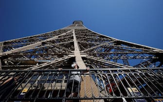 A visitor wearing a protective facemask admires the view from the Eiffel Tower during its partial reopening on June 25, 2020, in Paris, as France eases lockdown measures taken to curb the spread of the COVID-19 caused by the novel coronavirus. - Tourists and Parisians will again be able to admire the view of the French capital from the Eiffel Tower after a three-month closure due to the coronavirus -- but only if they take the stairs. (Photo by Thomas SAMSON / AFP) (Photo by THOMAS SAMSON/AFP via Getty Images)