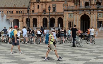 A tourist wearing a protective mask walks at Plaza de Espana in Seville on March 11, 2020 after Spain banned all air traffic from Italy, closed schools and blocked fans from football matches due to the coronavirus outbreak. - Coronavirus infections in Spain have passed the 2,000 mark with 47 deaths, the health ministry announced, making it Europe's second most severe outbreak after Italy. (Photo by CRISTINA QUICLER / AFP) (Photo by CRISTINA QUICLER/AFP via Getty Images)