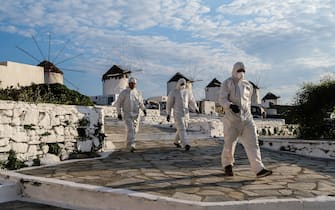 MYKONOS, GREECE - MAY 25: Contractors dressed in personal protective equipment (P.P.E.) remove debris from a home in the Little Venice neighborhood on May 25, 2020 in Mykonos, Greece. After months of being on lockdown due to the coronavirus, Greece will begin to ease travel restrictions on movement between the mainland and the countrys islands. (Photo by Byron Smith/Getty Images)