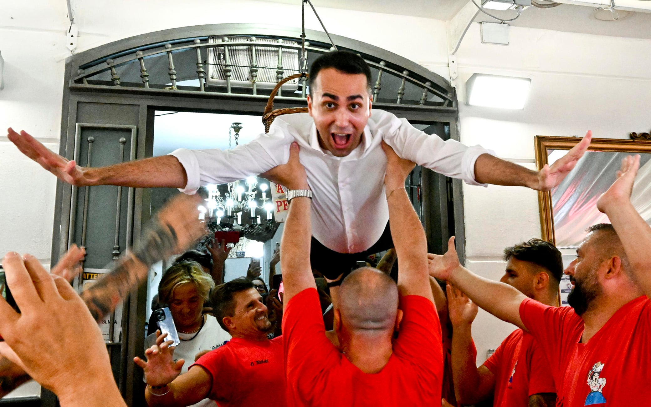 The leader of the Italian party "Impegno Civico" and Foreign Minister Luigi Di Maio raised in the air by the waiters of the folkloristic trattoria Nennella in imitation of the famous ballet staged by Patrick Swayze and Jennifer Gray in the film Dirty Dancing, on the occasion of a visit to the neighborhood of the Pignasecca, in Naples, September 14, 2022. ANSA/CIRO FUSCO