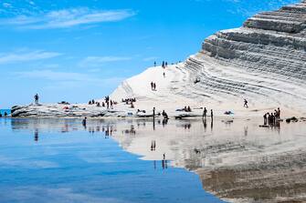 SCALA DEI TURCHI, REALMONTE, SICILY, ITALY - 2016/06/06: Sun-bakers at Scala dei Turchi, or Stairs of the Turks, at Realmonte, southern Sicily, Italy. The Scala is formed by marl, a sedimentary rock with a characteristic white color and is a popular tourist attraction and place to sun bake. (Photo by Leisa Tyler/LightRocket via Getty Images)