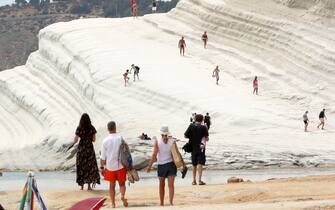 998436800 PORTO EMPEDOCLE,SICILY,ITALY - JUNE 6: A view of Scala Dei Turchi (Stair of the Turks) on June 06, 2018 in Scala Dei Turchi near Porto Empedocle, Italy. The Scala Dei Turchi is a rocky cliff on the coast of Realmonte in Sicily, Italy. Between two sandy beaches, and is accessed through a limestone rock formation in the shape of a staircase. The Scala is formed by marl, a white coloured sedimentary rock. (Photo by Franco Origlia/Getty Images)