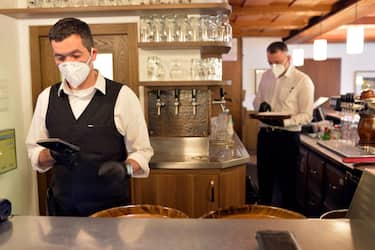 BOLZANO, ITALY - MAY 11: Waiters wear face masks at work in the restaurant after today's business reopening on May 11, 2020 in Bolzano, Italy. The Bolzano province started the reopening of some businesses one week earlier than the rest of Italy, arising many controversies. (Photo by Alessio Coser/Getty Images)