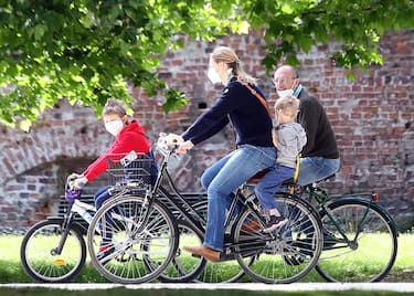Una famiglia  in bicicletta al parco Sempione di Milano  nel primo giorno della "Fase2" determinata dall'emergenza del Coronavirus. Milano 4 Maggio 2020.
ANSA / MATTEO BAZZI