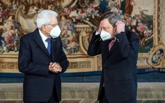 epa09008925 Italian President Sergio Mattarella and Italian Premier Mario Draghi (R) during the new government's swearing-in ceremony at the Quirinal Palace, in Rome, Italy, 13 February 2021.  EPA/ROBERTO MONALDO / POOL