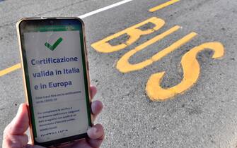A valid Green Pass for Italy and EU is diplayed on a smartphone while Italian Police and staff of AMT check the QR code confirming that people received the Covid-19 vaccine, at the Brignole bus stop in Genoa, Italy, 06 December 2021. The measures on the 'enhanced' green certificate (obtainable only with vaccination or recovery) come into effect from 06 December 2021 until 15 January 2022. EPA-ANSA/LUCA ZENNARO