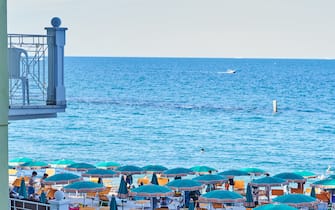 03 August 2021, Italy, Sirollo: The beach on the Italian coast near Sirollo, which belongs to the province of Ancona in the Marche region, is full of sunshades and bathers. Photo: Annette Riedl/dpa (Photo by Annette Riedl/picture alliance via Getty Images)
