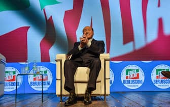 Leader of Italian right-wing party "Forza Italia", Silvio Berlusconi gets up from his chair to acknowledge applause on stage on September 23, 2022 at the Manzoni theater in Milan during a meeting closing his party's campaign for the September 25 general election. ANSA/MATTEO CORNER