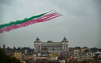 Planes of the Italian Air Force aerobatic unit Frecce Tricolori (Tricolor Arrows) spread smoke with the colors of the Italian flag as they fly over Rome on November 4, 2022 as part of celebrations of National Unity and Armed Forces Day, marking the end of the World War I in Italy. (Photo by Filippo MONTEFORTE / AFP) (Photo by FILIPPO MONTEFORTE/AFP via Getty Images)