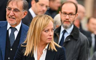 Italy's new Prime Minister, Giorgia Meloni (C) and President of the Italian Senate, Ignazio La Russa (L) attend a ceremony at the Altare della Patria monument in Rome on November 4, 2022 as part of celebrations of National Unity and Armed Forces Day, marking the end of the World War I in Italy. (Photo by Andreas SOLARO / AFP) (Photo by ANDREAS SOLARO/AFP via Getty Images)