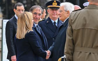 Italy's President Sergio Mattarella (C-R) shakes hand with Italy's Prime Minister, Giorgia Meloni (L) as President of the Italian Senate, Ignazio La Russa (3rdL) looks on, during a ceremony at the Altare della Patria monument in Rome on November 4, 2022 as part of celebrations of National Unity and Armed Forces Day, marking the end of the World War I in Italy. (Photo by Andreas SOLARO / AFP) (Photo by ANDREAS SOLARO/AFP via Getty Images)