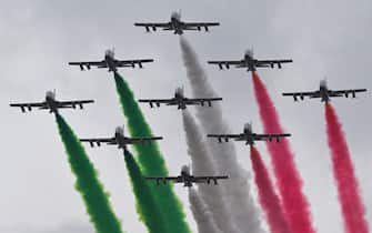 TOPSHOT - Planes of the Italian Air Force aerobatic unit Frecce Tricolori (Tricolor Arrows) spread smoke with the colors of the Italian flag as they fly over Rome on November 4, 2022 as part of celebrations of National Unity and Armed Forces Day, marking the end of the World War I in Italy. (Photo by Andreas SOLARO / AFP) (Photo by ANDREAS SOLARO/AFP via Getty Images)