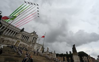 Planes of the Italian Air Force aerobatic unit Frecce Tricolori (Tricolor Arrows) spread smoke with the colors of the Italian flag as they fly over the Altare della Patria monument in Rome on November 4, 2022 as part of celebrations of National Unity and Armed Forces Day, marking the end of the World War I in Italy. (Photo by Andreas SOLARO / AFP) (Photo by ANDREAS SOLARO/AFP via Getty Images)