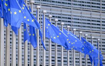 BRUSSELS, BELGIUM - JUNE 16: The EU flags flutter in the wind in front of the Berlaymont, the EU Commission headquarter on June 16, 2023 in Brussels, Belgium. The Flag of Europe, adopted on December 9, 1955, is a flag decorated with twelve five-pointed gold stars, one of the points pointing upwards, arranged at equal distance in a circle on a field of azure. It represents solidarity and union between the peoples of Europe. (Photo by Thierry Monasse/Getty Images)
