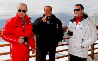Russia's outgoing President Dmitry Medvedev (R) and newly elected president Vladimir Putin (L) meet with former Italy's Prime minister Silvio Berlusconi at the Rosa Khutor apline ski resort in Krasnaya Polyana, some 50kms from Sochi on March 8, 2012. Italy's ex-prime minister Silvio Berlusconi flew into Russia for a lavish dinner with Vladimir Putin after his old ally's victory in presidential elections, state television said . AFP PHOTO/RIA-NOVOSTI/POOL/DMITRY ASTAKHOV / AFP / POOL / DMITRY ASTAKHOV        (Photo credit should read DMITRY ASTAKHOV/AFP via Getty Images)