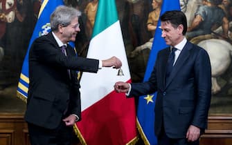Newly appointed Italian Prime Minister Giuseppe Conte receives, from the outgoing Prime Minister Paolo Gentiloni (L), the small silver bell to open the first council of Ministers at Chigi Palace in Rome, 1 Jun 2018. ANSA/ANGELO CARCONI