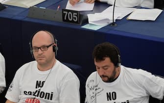epa04402533 (L-R) Italian members of the European Parliament (MEP) Gianluca Buonanno, Lorenzo Fontana and Matteo Salvini, of the Italian Lega Nord, wear protest t-shirts with the slogan 'No Sanzioni alla Russia' (No Sanctions on Russia) during the plenary session at the European Parliament in Strasbourg, France, 16 September 2014. The parliaments of Ukraine and the European Union were set 16 September to ratify a landmark political and free trade deal, but some lawmakers expressed displeasure over a delay in the agreement. The political and trade deal ratified by parliaments in Ukraine and the European Union were the first step towards membership in the bloc, Ukrainian President Petro Poroshenko said.  EPA/PATRICK SEEGER