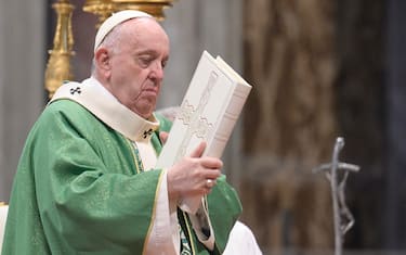 Pope Francis holds the Holy Book during a Mass in Saint Peter's Basilica for the Sunday of the Word of God. Vatican City, 23 January 2022. ANSA/CLAUDIO PERI