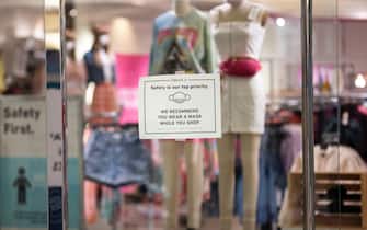 1219099331 MINNEAPOLIS, MN - JUNE 10: Signage hung on a window asks customers to wear a mask inside a store at the Mall of America on June 10, 2020 in Minneapolis, Minnesota. Today marks the first day the destination mall has been open since March due to coronavirus pandemic restrictions. (Photo by Stephen Maturen/Getty Images)