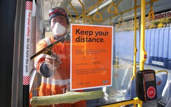 WELLINGTON, NEW ZEALAND - MAY 09: Senior Yard Supervisor Lipi Vitolio cleans the interior windows of a bus at Tranzit Bus Depot on May 09, 2020 in Wellington, New Zealand. The New Zealand government will decide whether to move to COVID-19 Alert Level 2 and ease further restrictions on Monday 11 May. Under Alert Level 2, businesses will be able to reopen with social distancing measures in place; public places will reopen; and domestic travel can recommence. Schools and early learning centres will be able to open and both indoor and outdoor gatherings up to 100 people will be allowed, while home gatherings should still remain small. Sport and recreation will also be able to restart, including professional sports competitions. New Zealand is current under COVID-19 Alert Level 3 restrictions, after the country was placed under full lockdown restrictions on March 26 in response to the coronavirus (COVID-19) pandemic. (Photo by Hagen Hopkins/Getty Images)