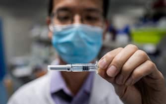 In this picture taken on April 29, 2020, an engineer shows an experimental vaccine for the COVID-19 coronavirus that was tested at the Quality Control Laboratory at the Sinovac Biotech facilities in Beijing. - Sinovac Biotech, which is conducting one of the four clinical trials that have been authorised in China, has claimed great progress in its research and promising results among monkeys. (Photo by NICOLAS ASFOURI / AFP) / TO GO WITH Health-virus-China-vaccine,FOCUS by Patrick Baert (Photo by NICOLAS ASFOURI/AFP via Getty Images)