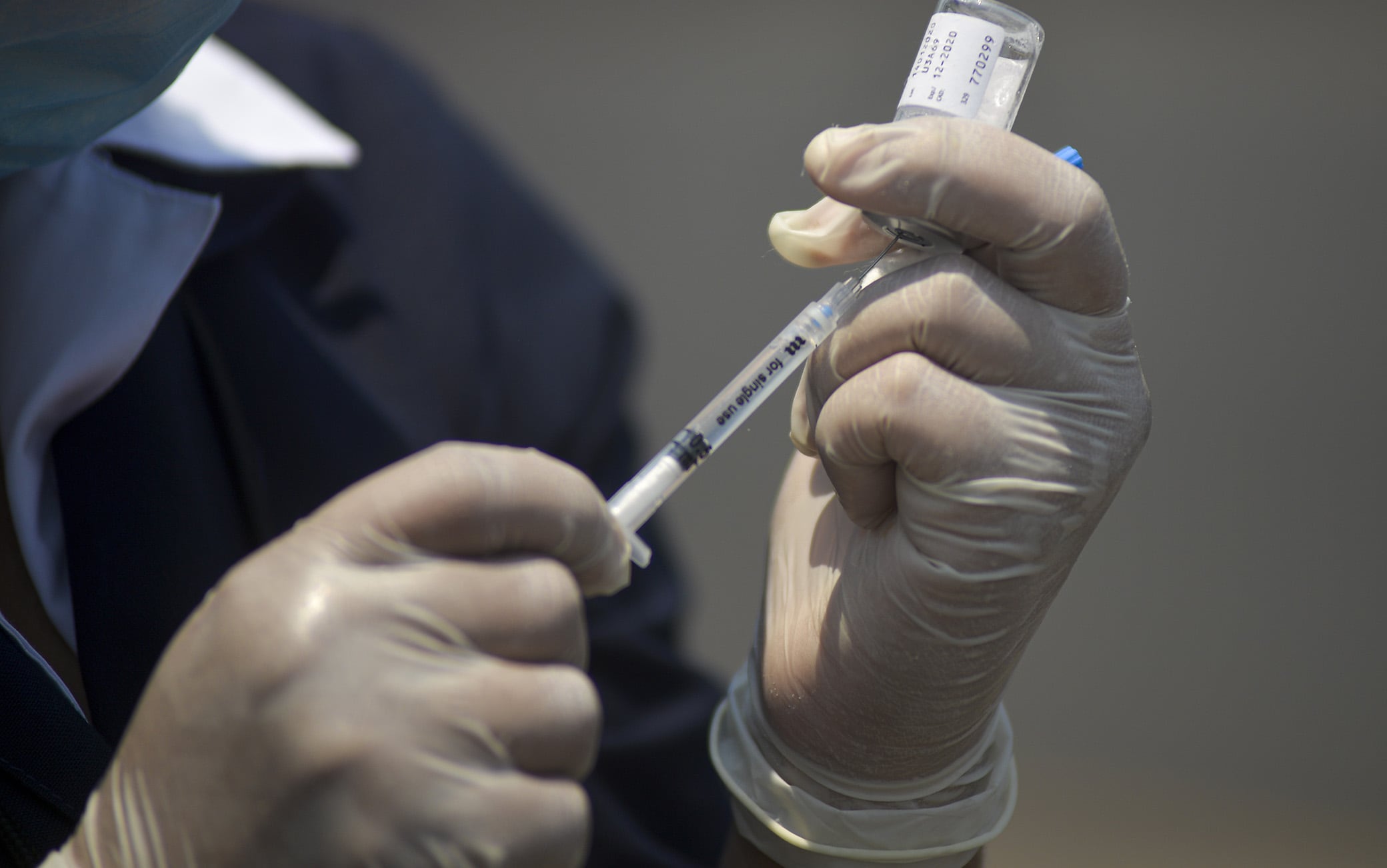 1209533836 SAN SALVADOR, EL SALVADOR - APRIL 08: A nurse extracts an influenza vaccine from its container on April 8, 2020 in San Salvador, El Salvador. President Nayib Bukele declared a 30-day mandatory quarantine and curfew to control the spread of the Coronavirus. 93 positive cases have been confirmed and 5 deaths related to the virus and over 1,200 people have been arrested for violating the mandatory quarantine and curfew. (Photo by Camilo Freedman/APHOTOGRAFIA/Getty Images)