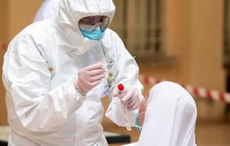 TEMPIO PAUSANIA, ITALY - MAY 21: The army doctor carries out a swab test for coronavirus (COVID-19)  on a nun inside the health facility on May 21, 2020 in Tempio Pausania, Italy. Italy has eased the lockdown due to the Covid-19 pandemic and many businesses are allowed to reopen after a full disinfection. (Photo by Emanuele Perrone/Getty Images)