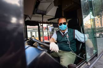 ROME, ITALY - APRIL 30: A man wearing a protective mask drives a public bus in Piazza Venezia area empty of tourists during the Coronavirus (COVID-19) pandemic, on April 30, 2020 in Rome, Italy. Italy will remain on lockdown to stem the transmission of the Coronavirus (Covid-19), slowly easing restrictions. (Photo by Silvia Lore/Getty Images)