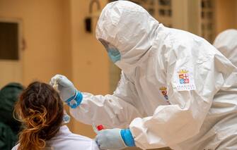 1226265670 TEMPIO PAUSANIA, ITALY - MAY 21: An Italian Navy doctor administers a Covid-19 test inside a health facility in Sardinia on May 21, 2020 in Tempio Pausania, Italy. Italy has eased the lockdown due to the Covid-19 pandemic and many businesses are allowed to reopen after a severe sanification. (Photo by Emanuele Perrone/Getty Images)