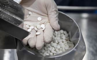 epa08508733 An employee holds tablets of the antiviral medication favipiravir at the laboratories of the Eva Pharma company in Cairo, Egypt, 25 June 2020. Favipiravir appears to have been proven effective in treating COVID-19 patients in Russia, while ongoing trials of the drug are taking place in Japan and other countries. In addition, the Egyptian drugmaker has reached a landmark deal with US company Gilead Sciences Inc. licensing the former to manufacture Gilead's antiviral drug remdesivir   another experimental treatment for patients suffering from the pandemic COVID-19 disease caused by the SARS-CoV-2 coronavirus   and distribute it in 127 countries.  EPA/MOHAMED HOSSAM