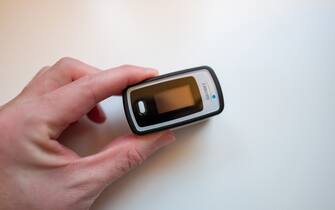 Close-up of human hand using a home pulse oximeter from Innovo to measure heartbeat and blood oxygen saturation, San Ramon, California, April 25, 2020. Pulse oximeters are often used in homecare for respiratory illnesses including the COVID-19 coronavirus. (Photo by Smith Collection/Gado/Getty Images)