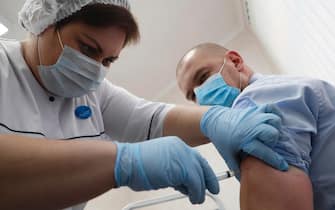 epa08863887 A Russian medic inoculating a man with Russia's vaccine against COVID-19 disease at a policlinic in Moscow, Russia, 05 December 2020. On 05 December, Moscow began a program for mass vaccination against COVID-19 disease, caused by SARS-CoV-2 coronavirus, using the Sputnik V vaccine.  EPA/MAXIM SHIPENKOV