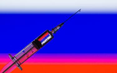 In this photo illustration a medical syringe seen displayed in front of the Russian Flag. (Photo by Thiago Prudêncio / SOPA Images/Sipa USA)