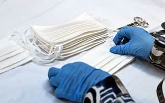 An employee sews masks in the Atelier Miroglio masks factory on March 17, 2020 in Alba, near Cuneo, Northwestern Italy. - Miroglio is a tissues factory that started to produce masks not for sanitary use after the COVID-19 coronavirus emergency. The masks are made of cotton with a waterproof treatment. (Photo by MARCO BERTORELLO / AFP) (Photo by MARCO BERTORELLO/AFP via Getty Images)