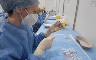 A health care worker prepares a dose of the Pfizer anti-Covid-19 vaccine at the new vaccination hub set up in Novegro, near Milan, Italy, 20 April 2021.ANSA/DANIEL DAL ZENNARO