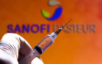 In this photo illustration the medical syringe is seen with Sanofi Pasteur company logo displayed on a screen in the background. (Photo by Rafael Henrique / SOPA Images/Sipa USA)