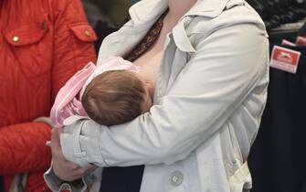 A mother discretely breastfeeds her baby in Sports Direct, Nottingham in a show of solidarity after a mother was asked to leave the store for breast feeding her baby earlier in the year.   (Photo by Joe Giddens/PA Images via Getty Images)