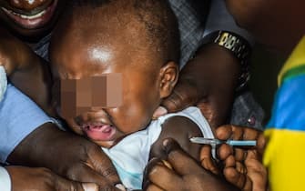 A child is vaccinated against malaria on September 13, 2019 in Ndhiwa, Homabaya County, Western Kenya during the launch of malaria vaccine in Kenya. - The vaccine (Mosquirix) is the world's first malaria vaccine that has been shown to provide partial protection against malaria in young children and has been rolled out by World Health Organisation in Kenya, Ghana and Malawi. (Photo by Brian ONGORO / AFP) (Photo by BRIAN ONGORO/AFP via Getty Images)