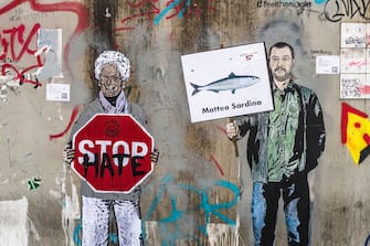 MILAN, ITALY - DECEMBER 07: The last mural by the Italian street artist TvBoy appeared this morning in the Navigli area in Milan are dedicated to Liliana Segre and Matteo Salvini on December 7, 2019 in Milan, Italy. The artist has designed a Salvini that manifests next to Liliana Segre that holds a sign with the words 'Stop Hate'. In the second mural Matteo Salvini becomes "Matteo Sardina" and is inspired by the new popular movement that fills the squares of Italy. (Photo by Fabrizio Villa/Getty Images)