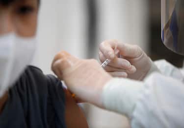 epa09478720 A Thai student receives a dose of Pfizer vaccine during a COVID-19 vaccination drive for children aged 12-18 with underlying illness before schools reopen, at Vajira hospital in Bangkok, Thailand, 21 September 2021. Thailand rolled out a vaccination drive against COVID-19 coronavirus for students aged 12-18 year-old with Pfizer vaccine before school reopens aims to speed up to reach 70 per cent of its population vaccinated goal for safely opening the country under the living with COVID-19 strategy.  EPA/RUNGROJ YONGRIT