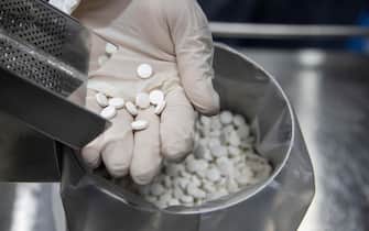 epa08508733 An employee holds tablets of the antiviral medication favipiravir at the laboratories of the Eva Pharma company in Cairo, Egypt, 25 June 2020. Favipiravir appears to have been proven effective in treating COVID-19 patients in Russia, while ongoing trials of the drug are taking place in Japan and other countries. In addition, the Egyptian drugmaker has reached a landmark deal with US company Gilead Sciences Inc. licensing the former to manufacture Gilead's antiviral drug remdesivir   another experimental treatment for patients suffering from the pandemic COVID-19 disease caused by the SARS-CoV-2 coronavirus   and distribute it in 127 countries.  EPA/MOHAMED HOSSAM